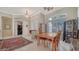 Bright dining area features tile flooring, an elegant chandelier, and plenty of natural light, perfect for gatherings at 241 Willow Bend Way, Osprey, FL 34229