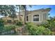 Attractive one-story home with well-maintained landscaping, a tile roof, and lush greenery, providing a welcoming curb appeal at 241 Willow Bend Way, Osprey, FL 34229
