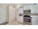Modern kitchen with stainless steel appliances and white cabinets at 241 Willow Bend Way, Osprey, FL 34229