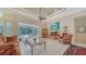 Bright living room with tile flooring, a ceiling fan and sliding door access to pool area at 241 Willow Bend Way, Osprey, FL 34229