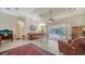 Spacious living room boasts tile flooring, a tray ceiling, and seamless access to the pool, perfect for entertaining at 241 Willow Bend Way, Osprey, FL 34229