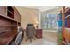 Home office featuring a built-in desk, shelving, storage, and a bright window at 241 Willow Bend Way, Osprey, FL 34229