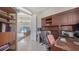 Home office with desk, shelves and view to open living area at 241 Willow Bend Way, Osprey, FL 34229