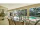 Covered patio with an outdoor table and view of the pool at 241 Willow Bend Way, Osprey, FL 34229