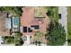 Aerial view of a house with solar panels and a screened-in pool, surrounded by lush landscaping at 2417 6Th Avenue E Dr, Bradenton, FL 34208