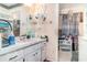 A dated bathroom featuring a pink sink, tile and blue shower curtain at 2417 6Th Avenue E Dr, Bradenton, FL 34208