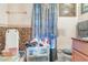 A dated bathroom featuring pink tile, toilet and sink with a blue and gray shower curtain at 2417 6Th Avenue E Dr, Bradenton, FL 34208