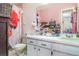 Cozy bathroom with pink walls, a vanity with a built-in sink, and a patterned shower curtain at 2417 6Th Avenue E Dr, Bradenton, FL 34208