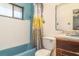 A dated bathroom featuring a blue bathtub and tile with a yellow and gray shower curtain at 2417 6Th Avenue E Dr, Bradenton, FL 34208