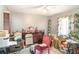 Bedroom with ceiling fan, a dresser, a chair and window with patterned curtains at 2417 6Th Avenue E Dr, Bradenton, FL 34208
