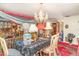 Decorated dining area with unique lighting fixtures, antique furniture, and red patterned carpeting at 2417 6Th Avenue E Dr, Bradenton, FL 34208