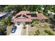 Angle view of home featuring solar panels, mature landscaping, and parking at 2417 6Th Avenue E Dr, Bradenton, FL 34208