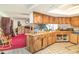 Spacious kitchen with wooden cabinetry, tile flooring, and an open layout to the living area at 2417 6Th Avenue E Dr, Bradenton, FL 34208