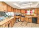 Functional kitchen with light wooden cabinets, ample counter space, and tile flooring at 2417 6Th Avenue E Dr, Bradenton, FL 34208