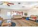 Spacious living room with unique tiger print carpet, ceiling fans, and traditional furnishings at 2417 6Th Avenue E Dr, Bradenton, FL 34208