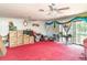 Large living room with two ceiling fans, sliding glass doors, and vintage decor at 2417 6Th Avenue E Dr, Bradenton, FL 34208