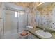 Cozy bathroom featuring a shower-tub combination, a decorative wallpaper, and a vanity with a sink at 2819 Swifton Dr # 9, Sarasota, FL 34231