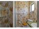Vintage bathroom featuring fern wallpaper, updated toilet, and open shelving for storage at 2819 Swifton Dr # 9, Sarasota, FL 34231