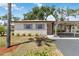 Charming single-story home featuring a carport, well-maintained landscaping, and light-colored exterior at 2819 Swifton Dr # 9, Sarasota, FL 34231