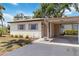 Charming single-story home featuring a carport, well-maintained landscaping, and light-colored exterior at 2819 Swifton Dr # 9, Sarasota, FL 34231