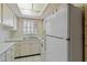 Bright kitchen features white cabinets, countertops, and appliances, with a skylight and tiled floor at 2819 Swifton Dr # 9, Sarasota, FL 34231