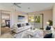 Cozy living room featuring a comfortable sofa, a glass door, and a view into the main bedroom at 2819 Swifton Dr # 9, Sarasota, FL 34231