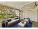 Relaxing sun room with ample seating, ceiling fan, tile floor, and views of the well-maintained landscaping at 2819 Swifton Dr # 9, Sarasota, FL 34231
