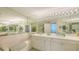 Bright bathroom features a soaking tub, dual sinks, and a large mirror at 3080 Grand Bay Blvd # 533, Longboat Key, FL 34228