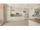 Spacious kitchen with white cabinetry, granite counters, and tiled floor at 3080 Grand Bay Blvd # 533, Longboat Key, FL 34228