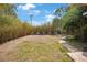 A spacious backyard with a swing set and path creates a warm place for Gathering activities at 316 29Th W St, Bradenton, FL 34205