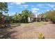 A large backyard featuring a playground and mature trees, perfect for outdoor activities and relaxation at 316 29Th W St, Bradenton, FL 34205