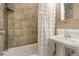 Small bathroom with a tile shower, tub, and a pedestal sink at 316 29Th W St, Bradenton, FL 34205
