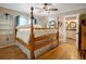 Bedroom boasts hardwood floors, a four-poster bed, and modern ceiling fan at 316 29Th W St, Bradenton, FL 34205