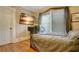 Comfortable bedroom featuring hardwood floors, neutral walls, and a large window at 316 29Th W St, Bradenton, FL 34205