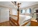 Bedroom features hardwood floors, a four-poster bed, and modern ceiling fan at 316 29Th W St, Bradenton, FL 34205