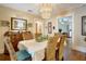 A formal dining room features hardwood floors and a decorative chandelier at 316 29Th W St, Bradenton, FL 34205