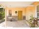 Inviting front porch with brick flooring and stone accents offers a warm welcome to this charming home at 316 29Th W St, Bradenton, FL 34205