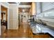 An open kitchen features stainless appliances and wood cabinetry and an island at 316 29Th W St, Bradenton, FL 34205