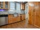 Well-lit kitchen with stainless steel appliances, wood cabinetry, and a farmhouse sink, creating a chef's dream at 316 29Th W St, Bradenton, FL 34205