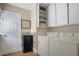 Functional laundry room features white washer and dryer, storage cabinets, and modern finishes at 316 29Th W St, Bradenton, FL 34205