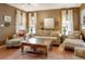 Comfortable living room with warm neutral color scheme is filled with natural light from large windows and stylish decor at 316 29Th W St, Bradenton, FL 34205