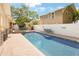 Backyard featuring an inviting swimming pool, brick patio, white fence, landscaping, and a bench to relax and enjoy the outdoors at 316 29Th W St, Bradenton, FL 34205