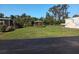 Lush backyard featuring a charming gazebo, mature trees, and a well-manicured lawn at 320 Tropic Dr, Osprey, FL 34229