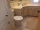 Cozy bathroom features a white toilet, a sink with a yellow countertop, and a vanity mirror at 320 Tropic Dr, Osprey, FL 34229