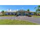 Attractive community clubhouse featuring a bright white exterior, manicured landscaping, and charming curb appeal at 320 Tropic Dr, Osprey, FL 34229