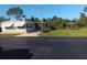 Charming home exterior with awnings, a screened-in porch, and a well-maintained lawn and gazebo at 320 Tropic Dr, Osprey, FL 34229