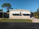 Charming single-story home with awnings, brick foundation, and a well-maintained lawn at 320 Tropic Dr, Osprey, FL 34229