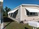 Tan mobile home featuring awnings for sun protection at 320 Tropic Dr, Osprey, FL 34229