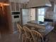 Traditional kitchen features a center island cooktop and retro built-in oven for a nostalgic feel at 320 Tropic Dr, Osprey, FL 34229