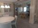 Living room with dining area and view into kitchen with cooktop island at 320 Tropic Dr, Osprey, FL 34229